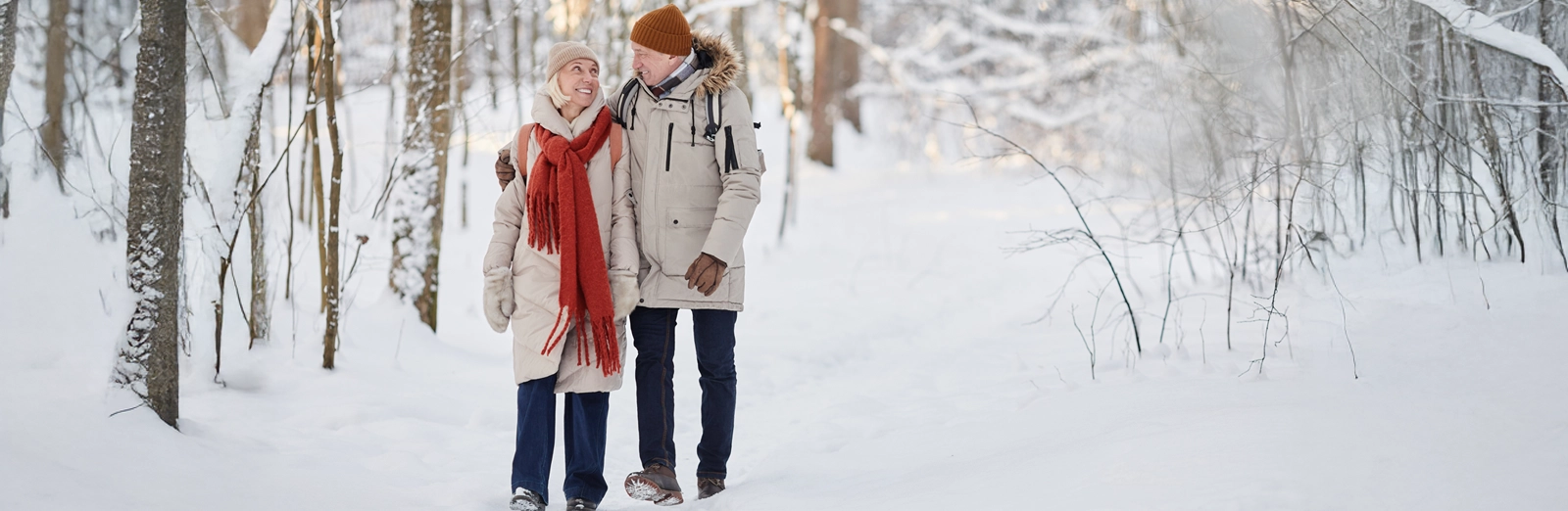 couple-walking-on-snowy-path-1600x522.webp