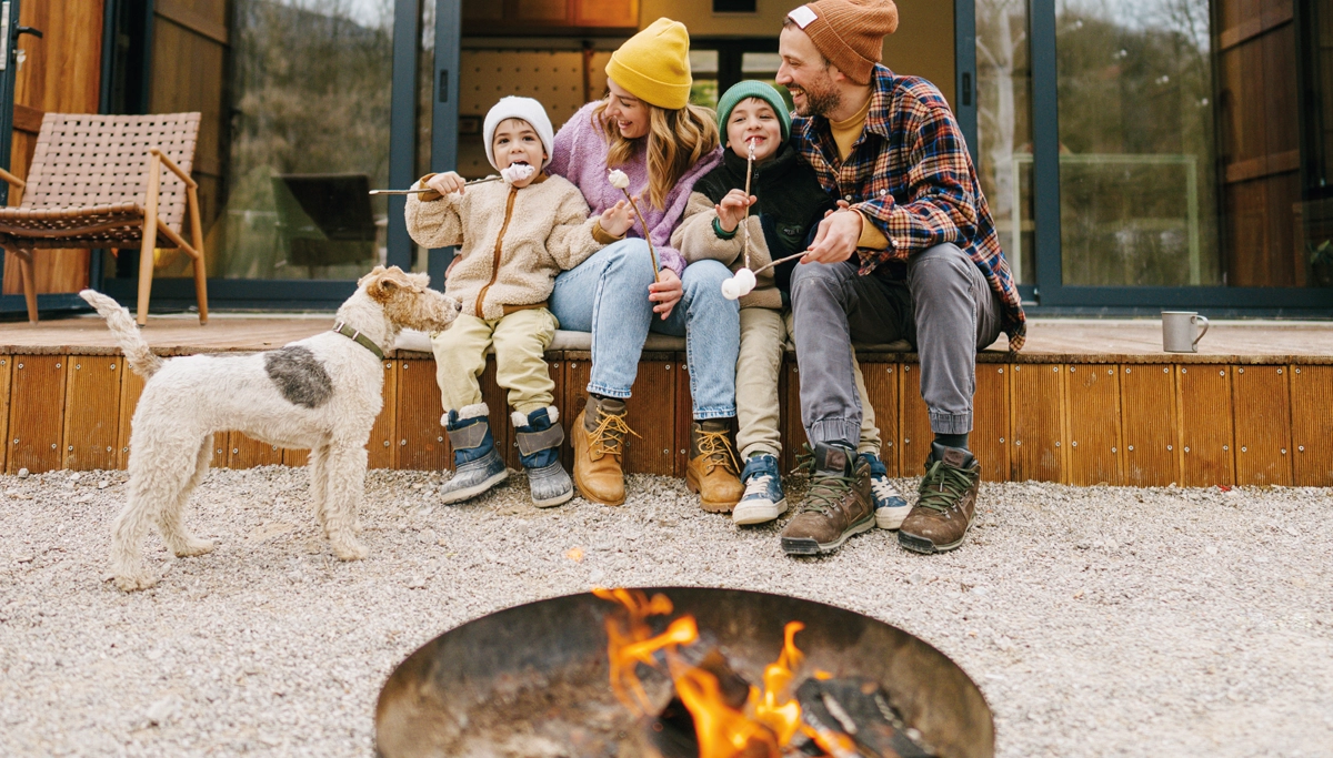 family-sitting-around-a-fire-1200x683.webp