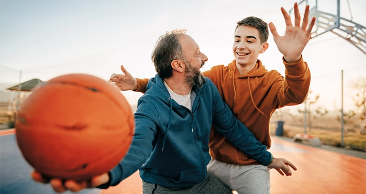 two-men-playing basketball-752x400.webp