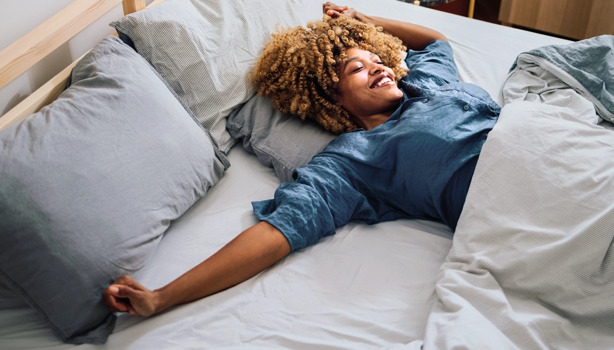 woman-smiling-in-bed-1200x683.webp